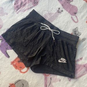 Grey Nike shorts. Size Medium. Tie can tighten the shorts. Two pockets.